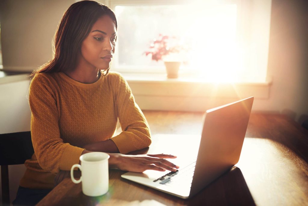 Woman Working On Laptop With Bright Sunlight